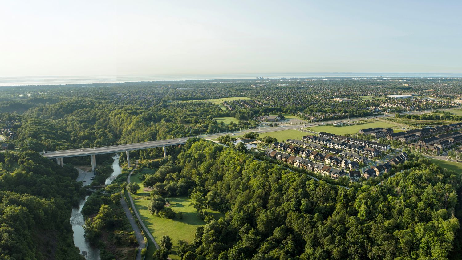 Five Oaks Oakville by Caivan — Community Aerial rendering of new townhomes and single detached homes